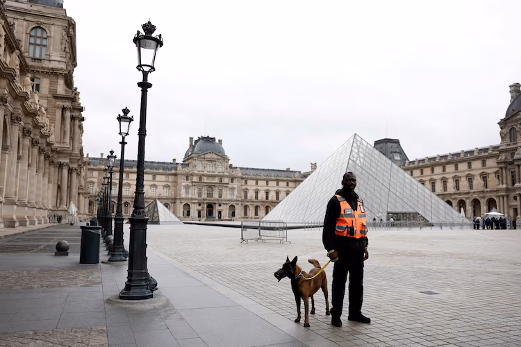 Security guard and dog outside the Louvre.