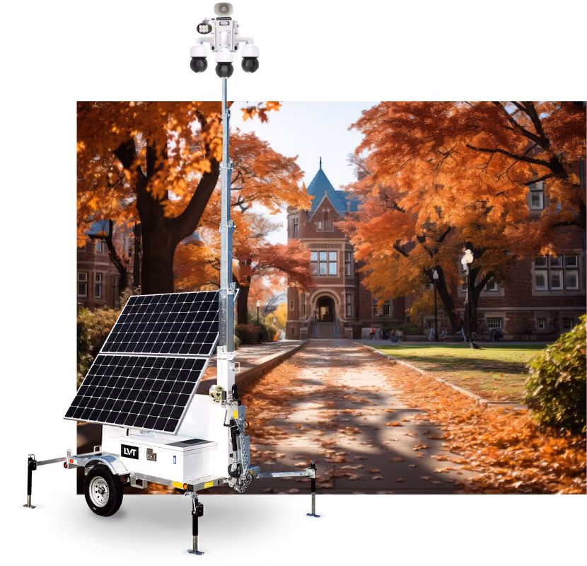 An LVT mobile security unit trailer positioned in front of a brick campus building surrounded by fall foliage.