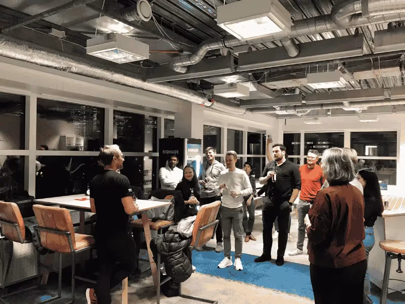 People engaging in a casual indoor event with presentations and group discussions.
