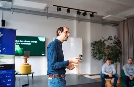 Nathan Bonnisseau speaks at an event as attendees watch from their seats.