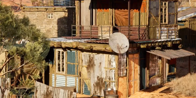 Rustic house made of wood and metal in a dry, rural landscape.