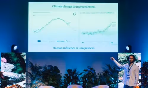 A presenter gestures toward slides showing climate change graphs, with text stating "Climate change is unprecedented. Human influence is unequivocal."