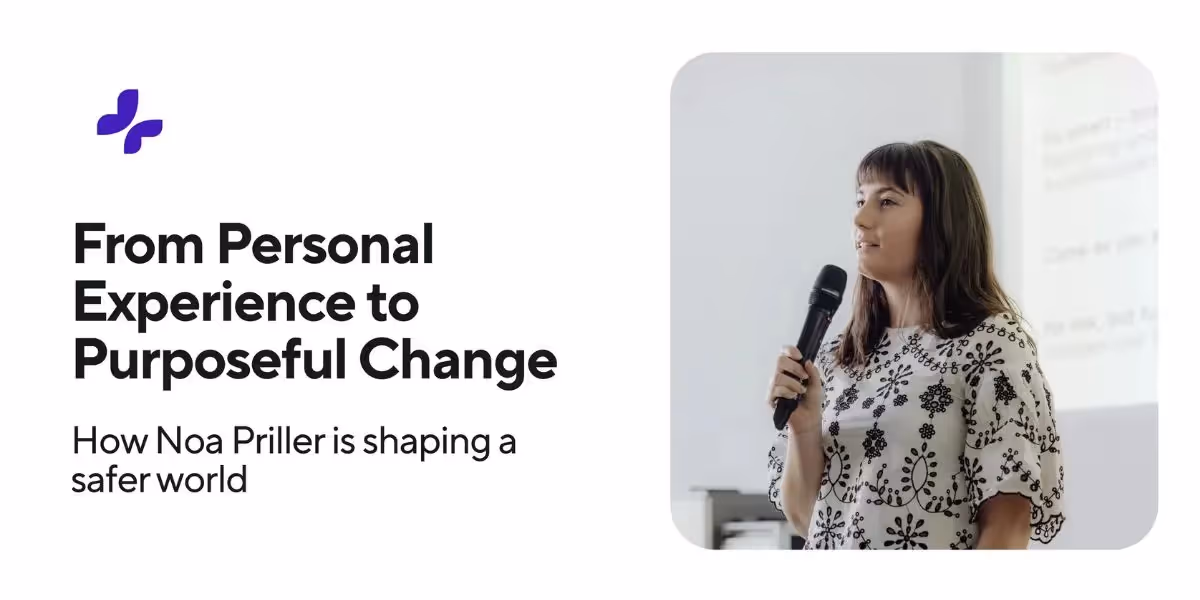 Woman speaking into a microphone in a bright room, sharing her story of shaping a safer world through personal experience and purposeful change.