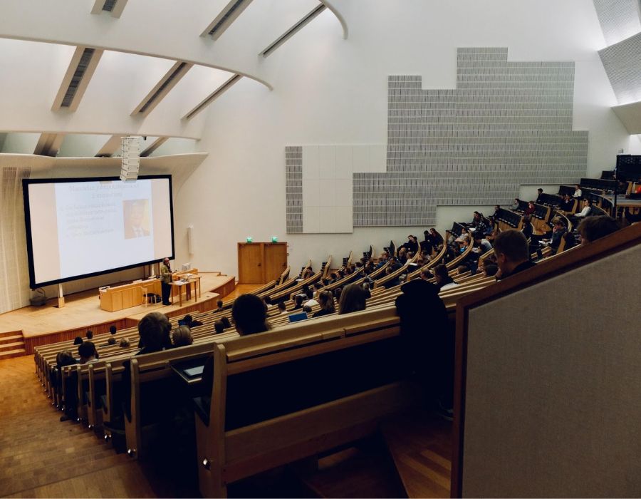Lecture hall with students listening to a lecture presentation