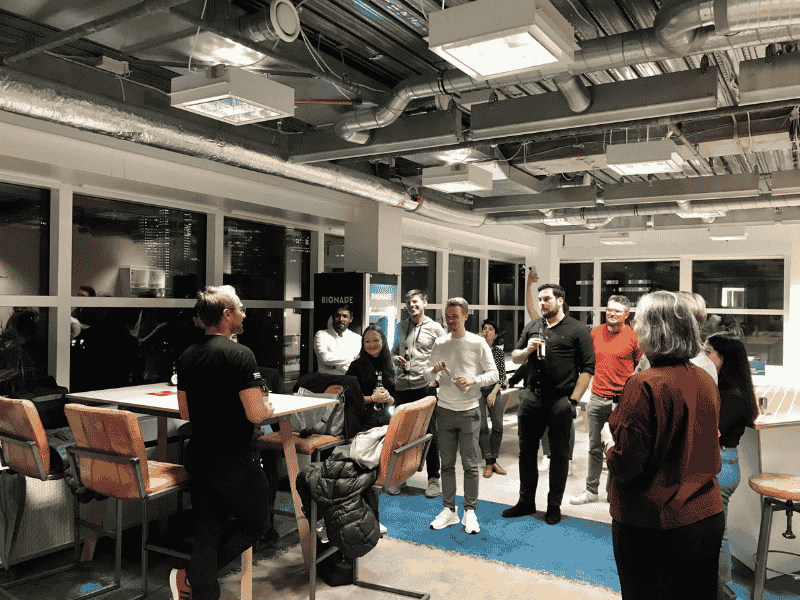 People engaging in a casual indoor event with presentations and group discussions.