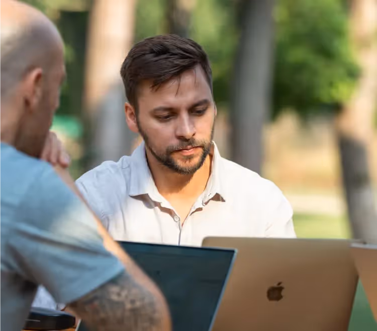 Prof. Dr. Jonathan Costa working with his laptop in an outside environment.
