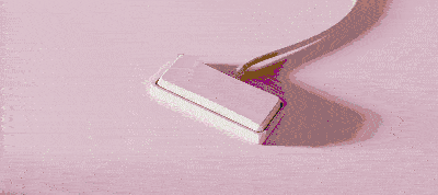 GIF showing a paint roller painting a light pink color over a wooden surface.