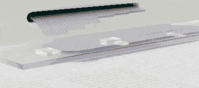 Animation showing a close-up of a black comb touching and lifting a transparent, rectangular object on a light surface.