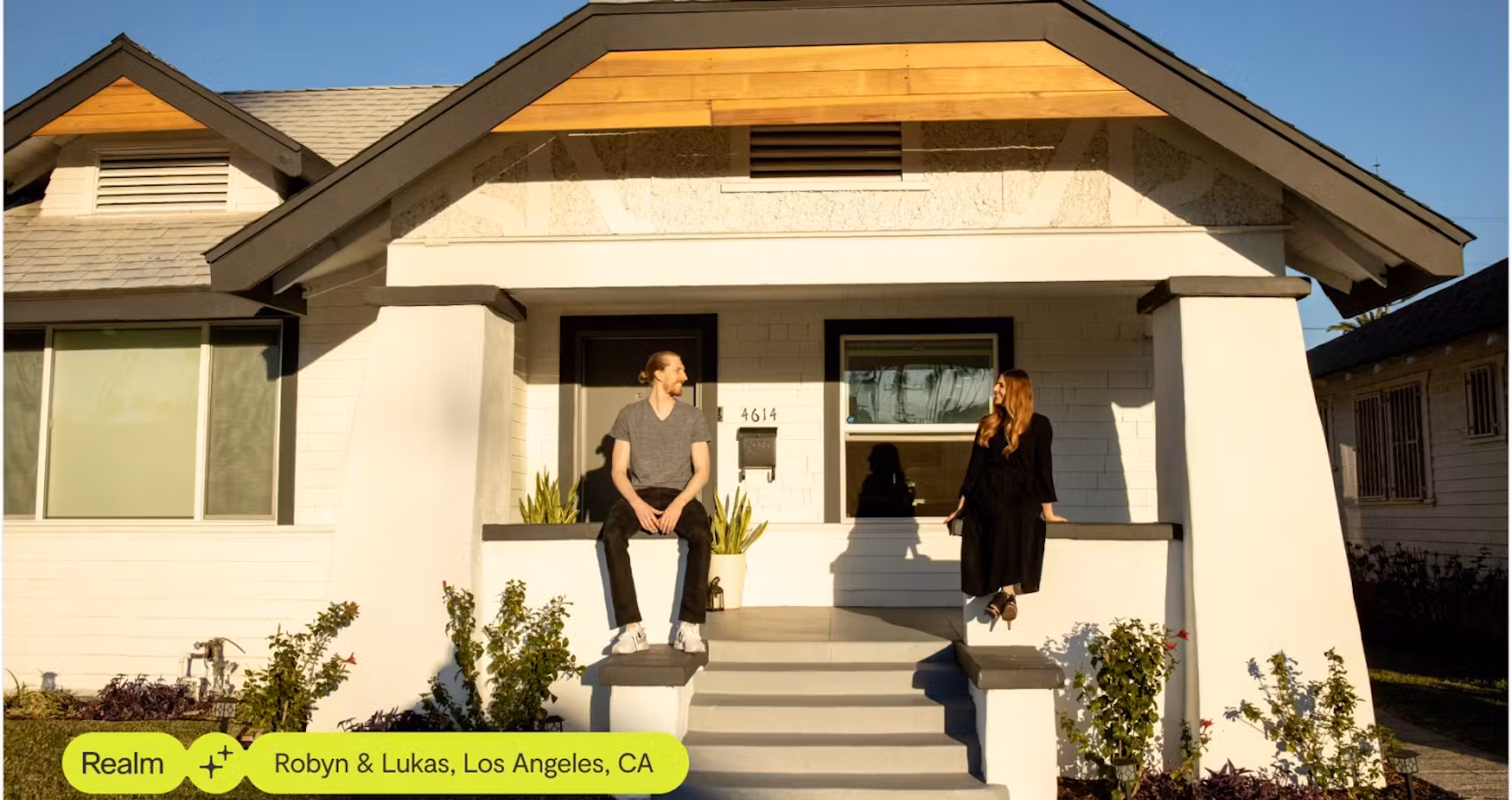 Couple sitting on the front steps of their remodeled home in Los Angeles, California.