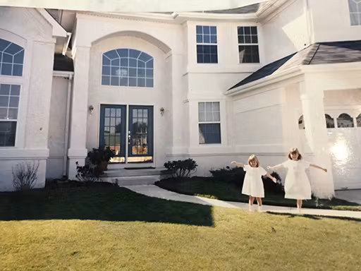 Liz and her sister in front of their childhood home in South Jersey