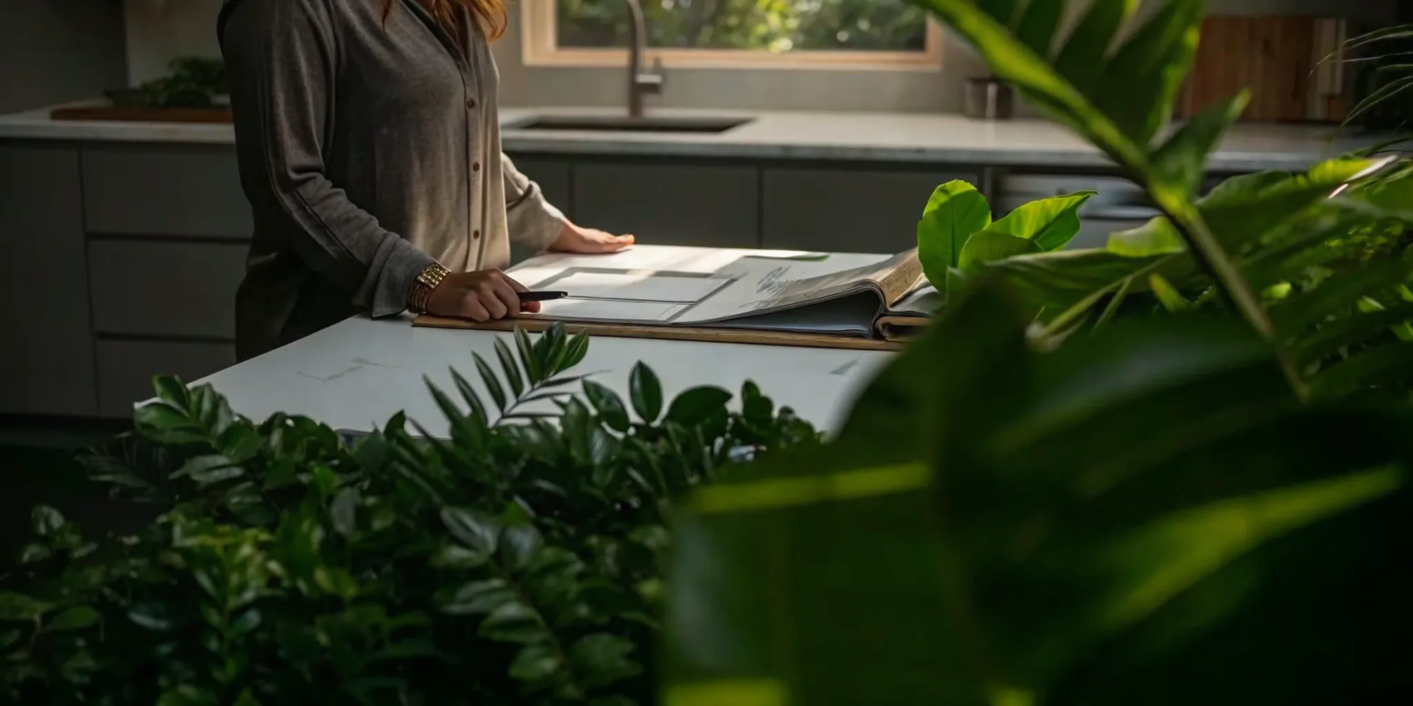 Homeowner reviewing renovation bid documents at a kitchen counter.