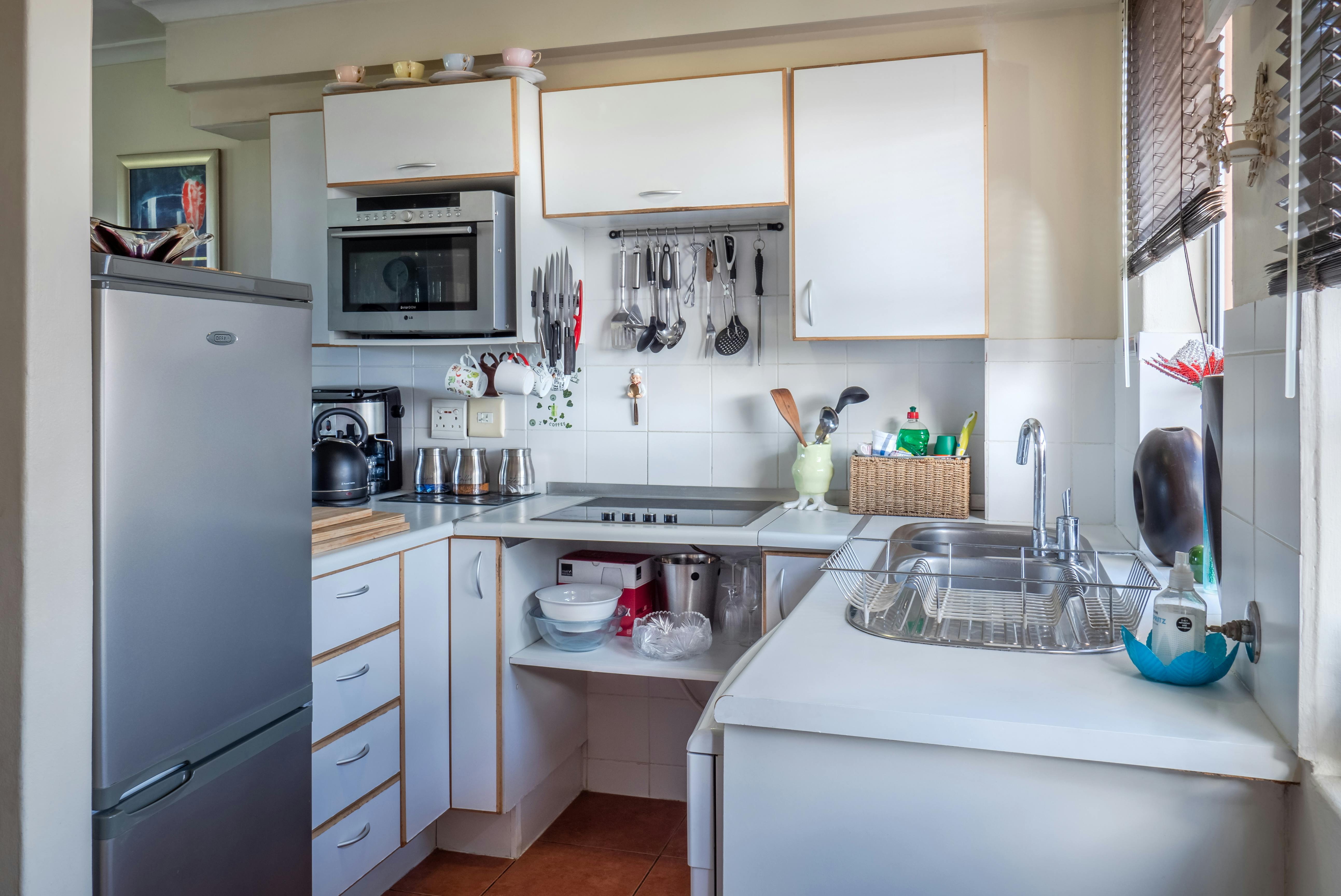 Modern ADU kitchenette with compact appliances in a California backyard unit