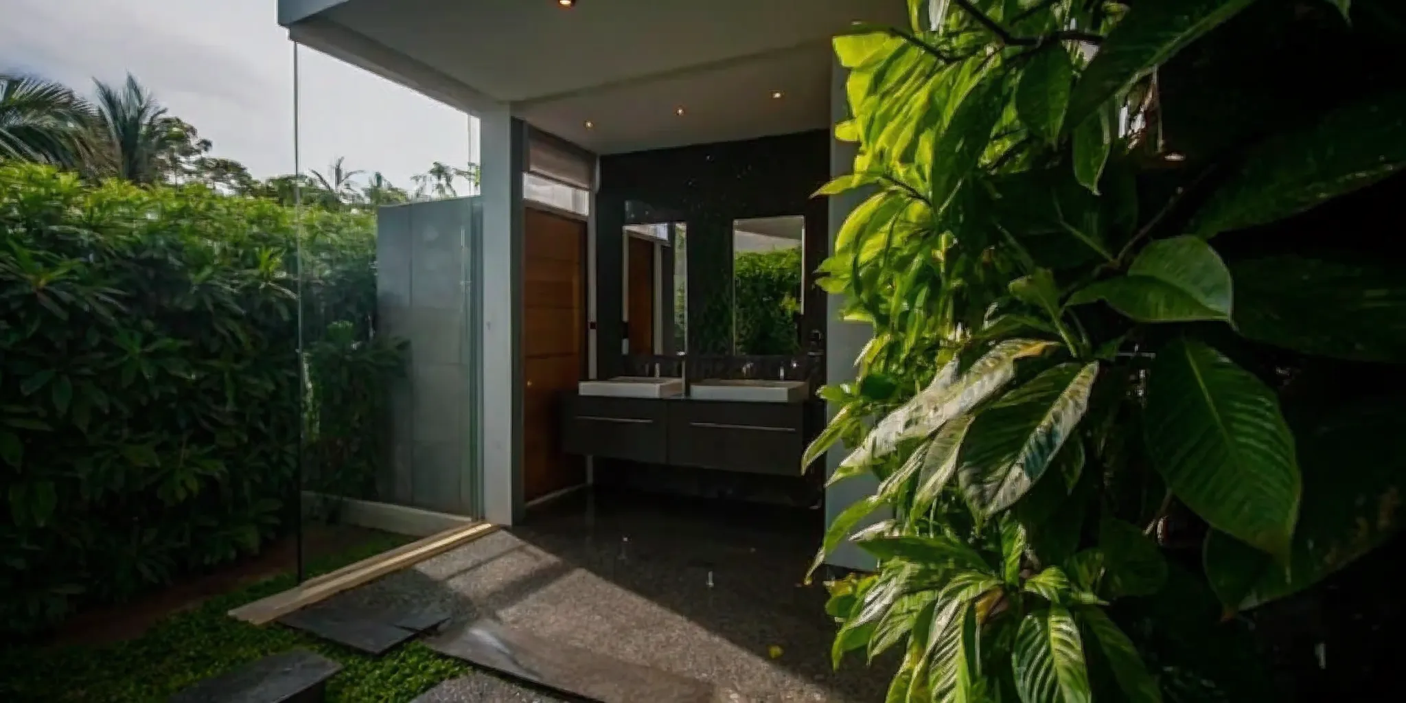 Modern master bathroom with glass-enclosed shower and double vanity