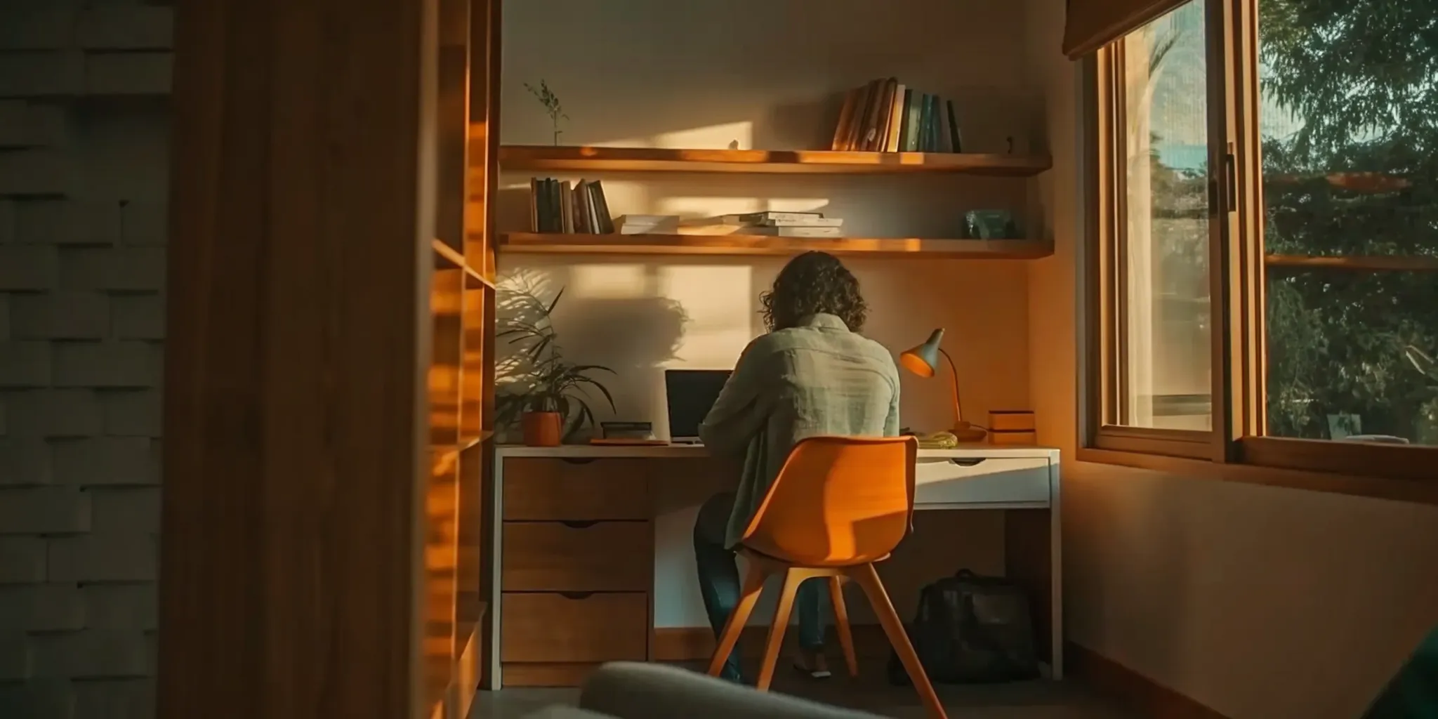 Bright, productive home office in a converted room with a desk, shelving, and natural light