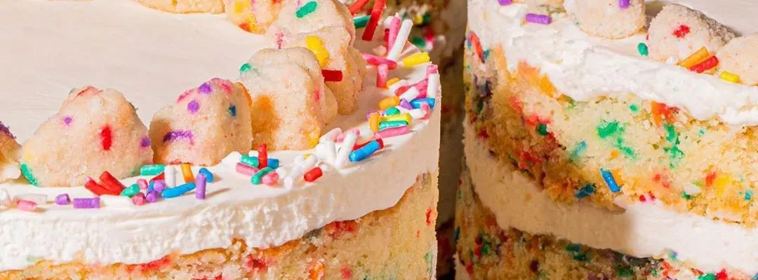 Layered birthday cake with colourful sprinkles