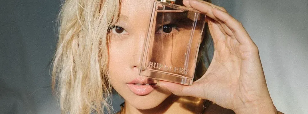woman holding a burberry perfume