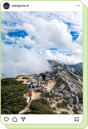 3 hikers walking through mountain trail with blue sky and clouds in background