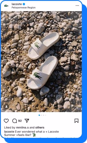 white lacoste slides on rocky beach