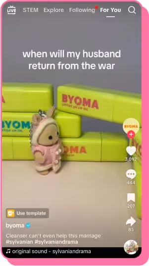 calico critter standing in front of byoma skincare products