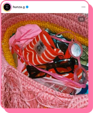 pink beach bag with bathing suit sunglasses and other summer essrntials