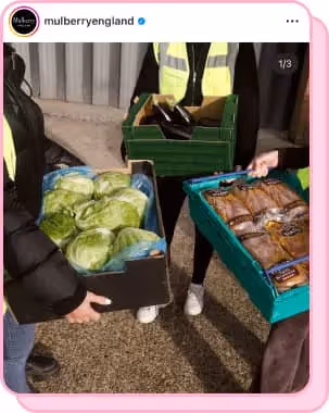 two people holding boxes of food for charity 