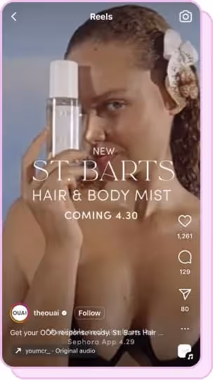 girl with flower in hair holding up body and hair mist bottle