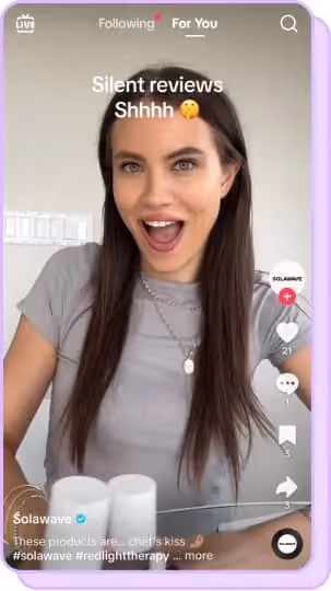 brunette woman in gray shirt smiling wide 