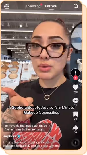 sephora employee with glasses pointing out favorites in-store