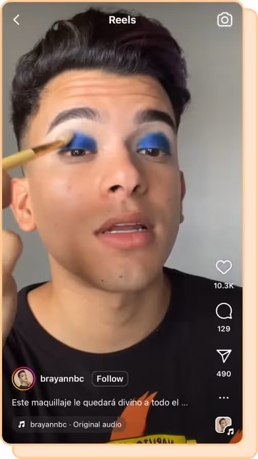man applies blue eyeshadow