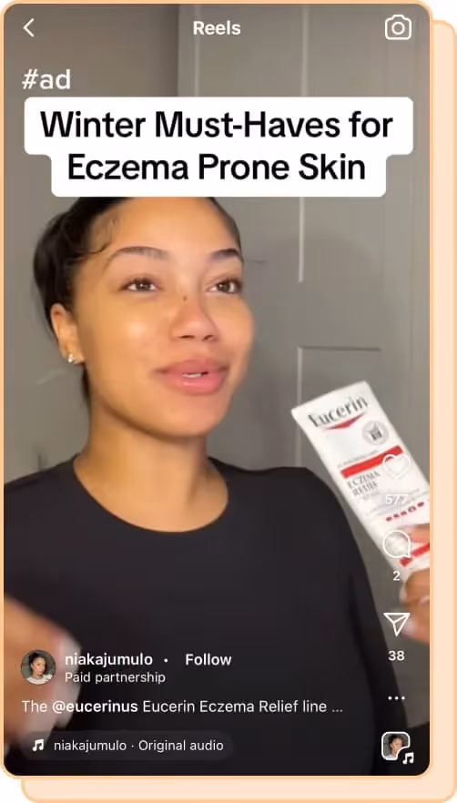woman wears black tshirt and holds eucerin cream