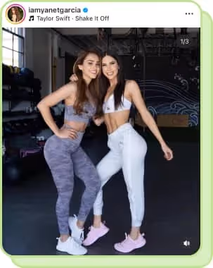 two women in fitness apparel posing in gym
