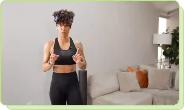 woman in living room wearing black workout set sharing youtube workout