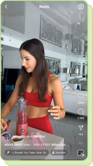 woman in workout clothes making a smoothie
