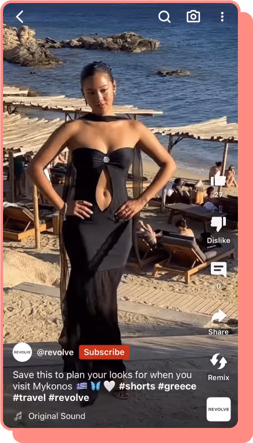 woman in black cutout dress standing on beach