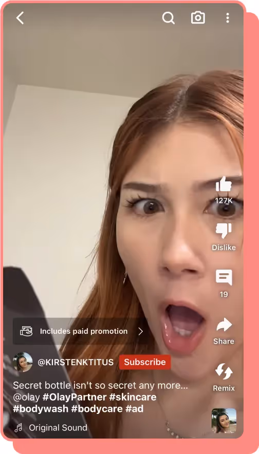 woman with surprised look on face looks at phone