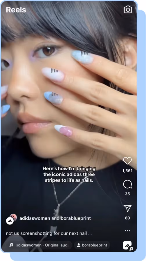 girl holding adidas blue, white and pink nails by face adidas ig reels screenshot 