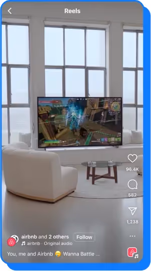 a modern living room with a large TV showing a video game and two white armchairs