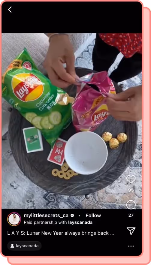 hands opening bag of lays chips with a bowl and cucumber lays chips beside it
