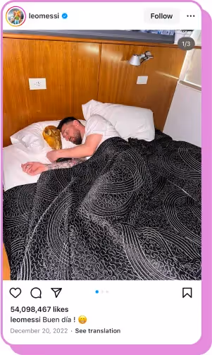 Soccer player sleeping in bed, cuddling the FIFA World Cup trophy under patterned blankets