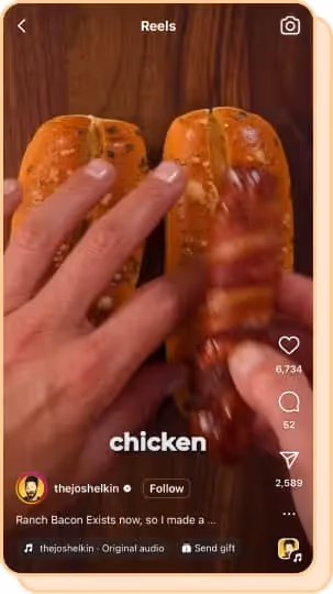 person putting chicken sausage into seasoned bun