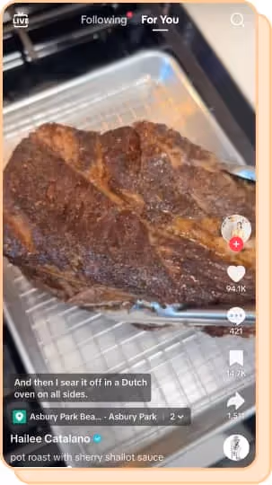 person picking up pot roast with stainless steel tongs