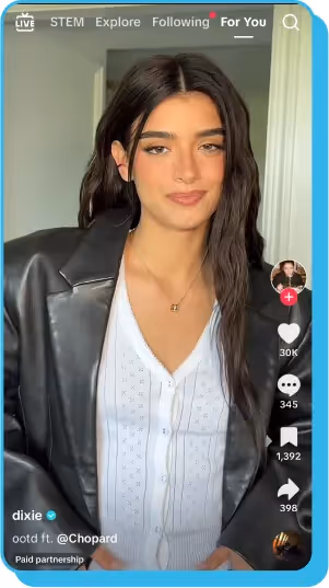 TikTok video of a creator in a black jacket and white top, showcasing an outfit in a sponsored post
