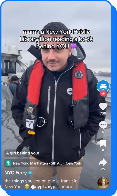 Man in a life vest standing on a ferry with a cityscape in the background
