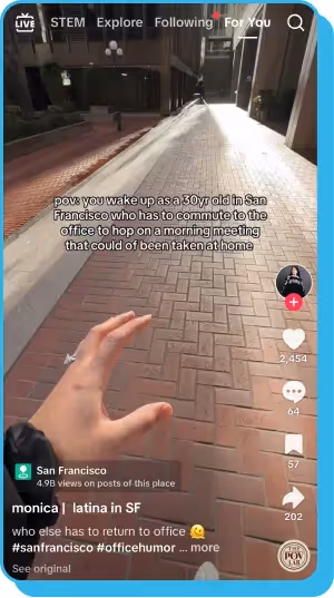 First-person view of a hand reaching out while walking down a brick-paved alley in San Francisco.