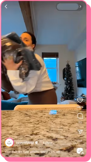 Woman hugs large bundle of clothes in cozy living room decorated for holidays