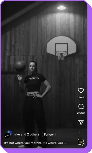 Woman in Nike gear holding basketball in moody black-and-white gym scene