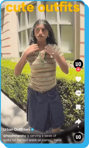 TikTok video of a woman posing outside in a striped top and denim skirt.