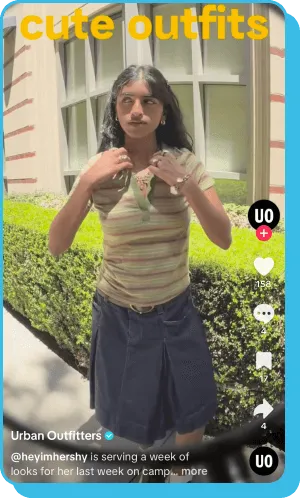 TikTok video of a woman posing outside in a striped top and denim skirt.