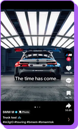 Rear view of BMW race car in garage with “The time has come…” text overlay 