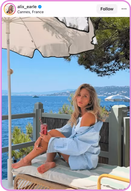 alix earle, woman in Cannes by ocean holding drink in Instagram post